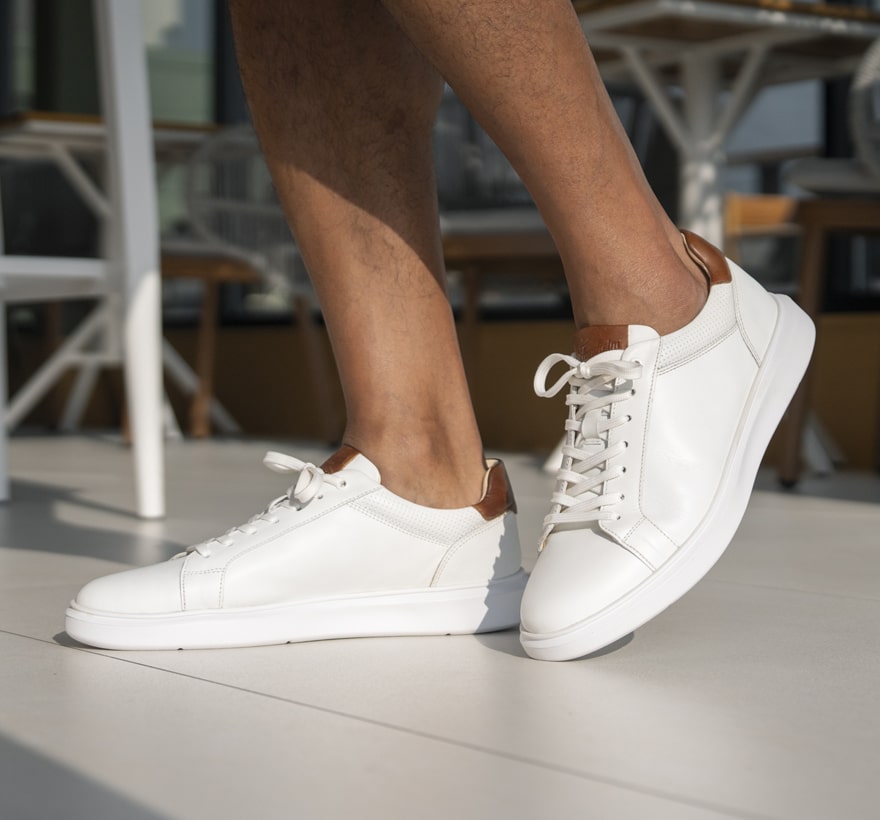 Image features the Social sneaker in white on a tile floor.