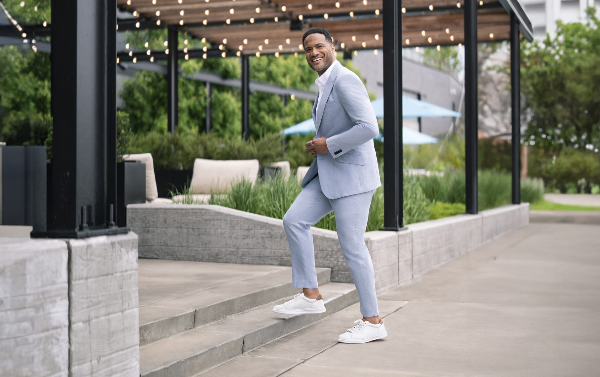 Florsheim casuals featuring the Social sneaker in white on a man in a grey suit. 