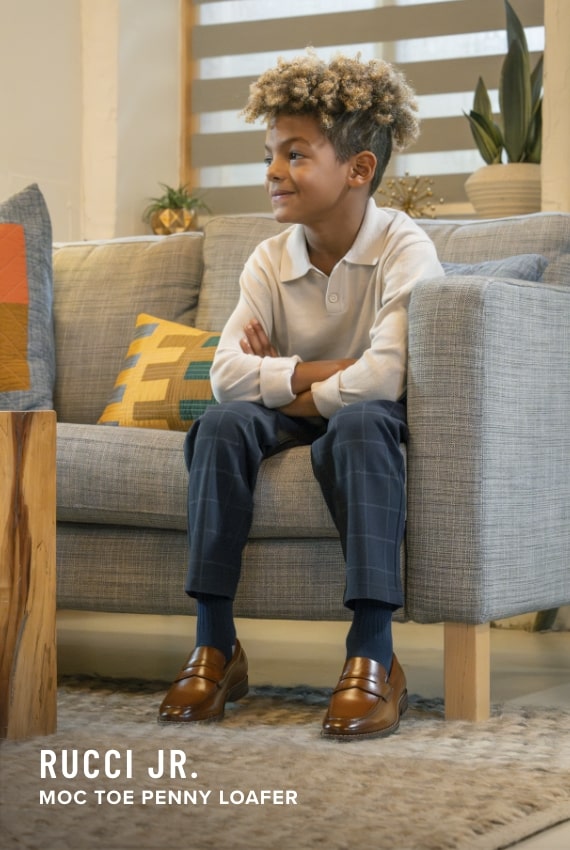 Kids Shoes view all category. Image features the Rucci Jr. Penny Loafer in cognac.