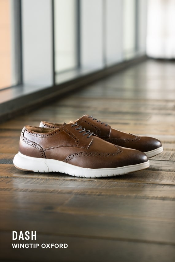 Lodge Collection Image features the Dash Wingtip Oxford on a wood floor. 